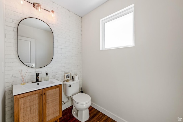 4712 W S Jordan Pkwy S, South Jordan, UT 84009 - half bathroom with toilet, wood finished floors, brick wall, baseboards, and vanity