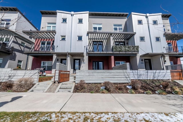 multi unit property with stucco siding and fence
