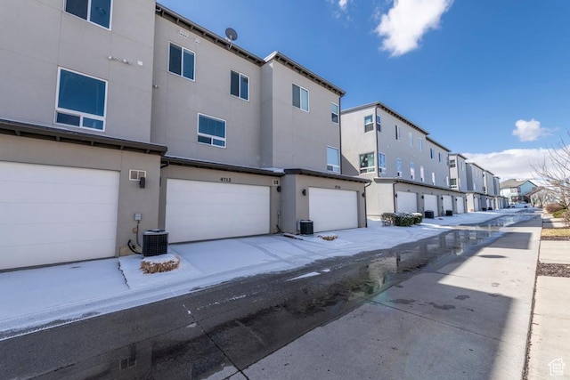 4712 W S Jordan Pkwy S, South Jordan, UT 84009 - rear view of property featuring stucco siding, a residential view, a garage, and cooling unit