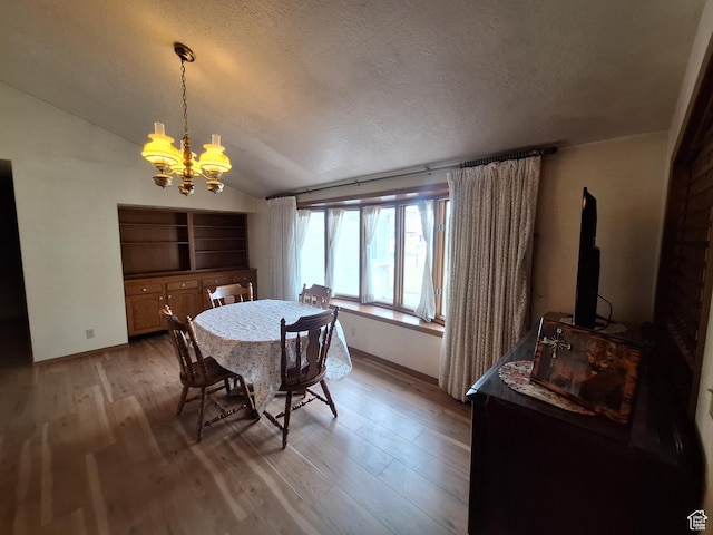 2801 W 1900 N, Plain City, UT 84404 - dining area with baseboards, vaulted ceiling, a textured ceiling, a notable chandelier, and light wood-type flooring