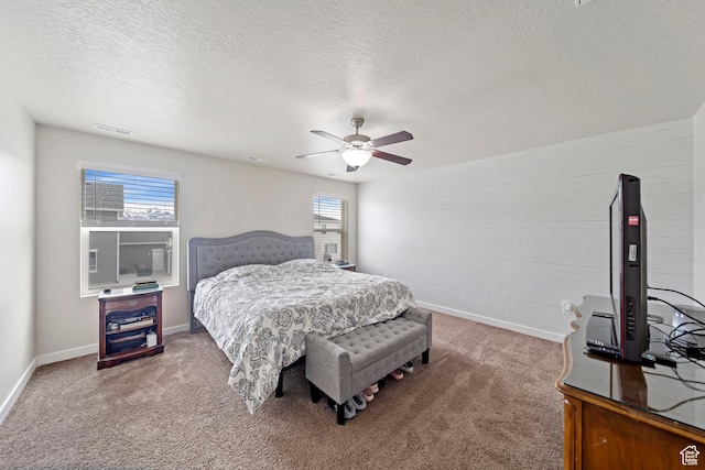 bedroom with visible vents, baseboards, ceiling fan, and carpet floors