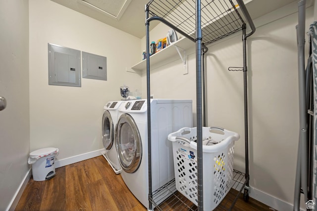 laundry area featuring washer and dryer, laundry area, electric panel, and wood finished floors