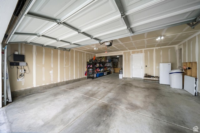 garage with a garage door opener and water heater
