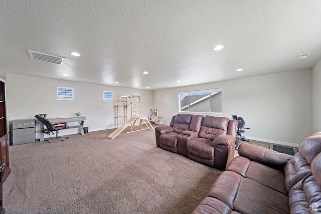 carpeted living room featuring visible vents, recessed lighting, and a textured ceiling