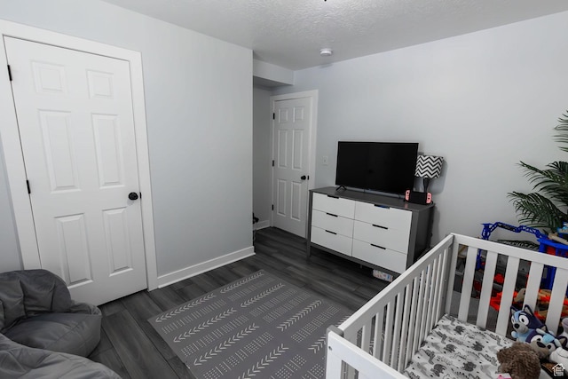 832 S 1430 E, Spanish Fork, UT 84660 - bedroom with dark wood-style flooring, baseboards, a nursery area, and a textured ceiling