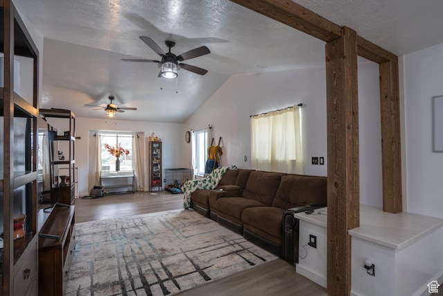 4072 N White Pine Rd E, Eagle Mountain, UT 84005 - living room with a ceiling fan, vaulted ceiling, wood finished floors, and a textured ceiling