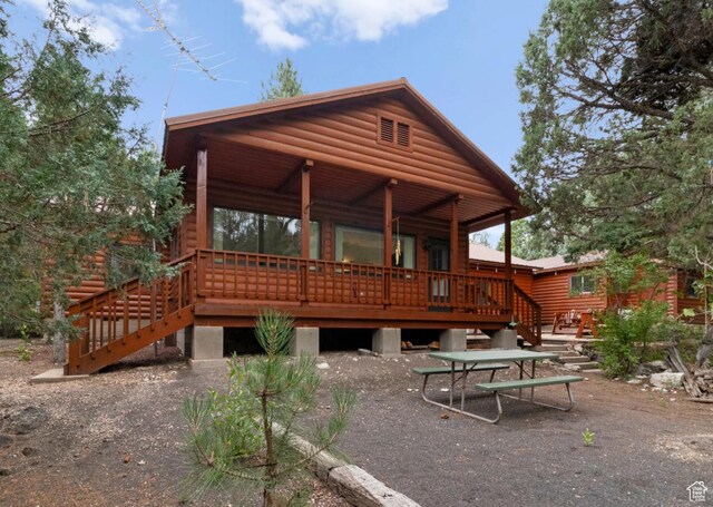 1372 S Cottonwood Ln, Hatch, UT 84735 - rear view of property featuring a porch and faux log siding