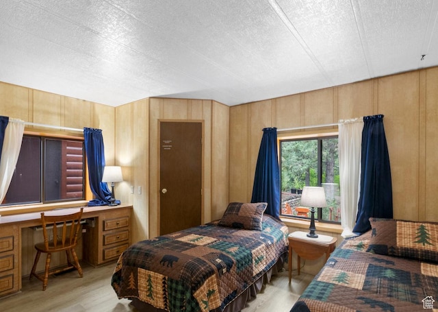 1372 S Cottonwood Ln, Hatch, UT 84735 - bedroom featuring wood finished floors, built in desk, and a textured ceiling