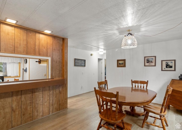 1372 S Cottonwood Ln, Hatch, UT 84735 - dining room featuring light wood-type flooring and wood walls