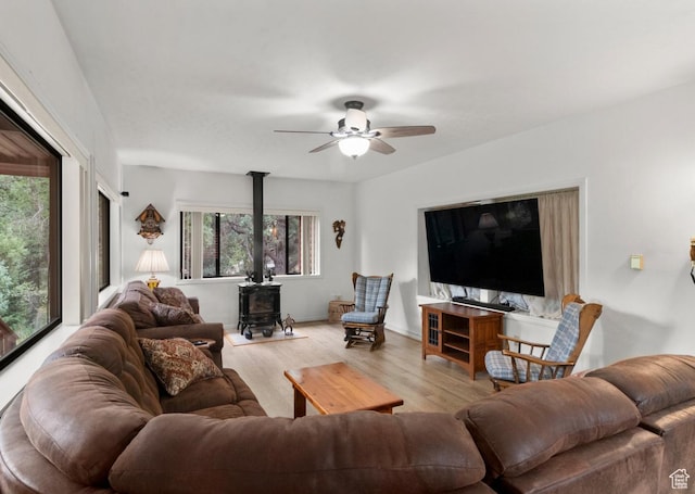 1372 S Cottonwood Ln, Hatch, UT 84735 - living area featuring baseboards, a wood stove, ceiling fan, and wood finished floors