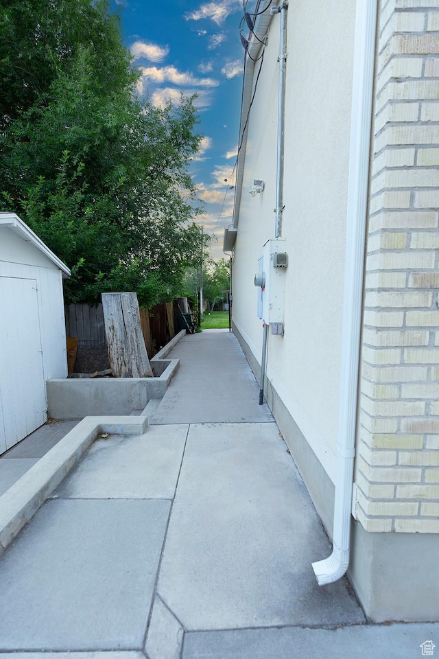 exterior space featuring a storage unit, an outdoor structure, and fence