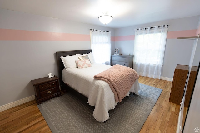 bedroom featuring light wood-type flooring and baseboards