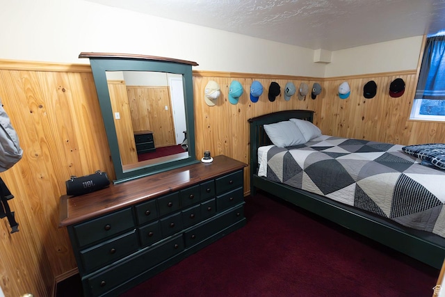 bedroom with a textured ceiling and wooden walls
