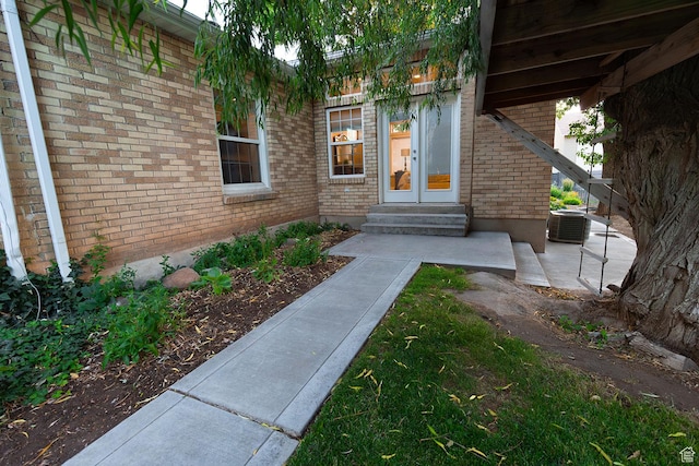 entrance to property featuring brick siding