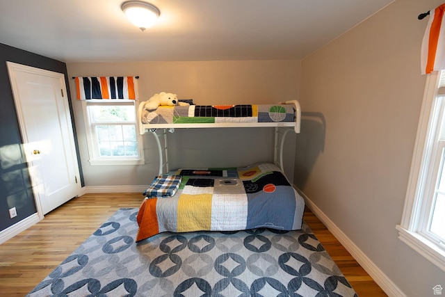 bedroom featuring wood finished floors and baseboards