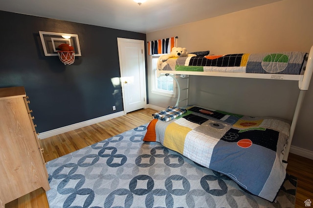 bedroom featuring wood finished floors and baseboards