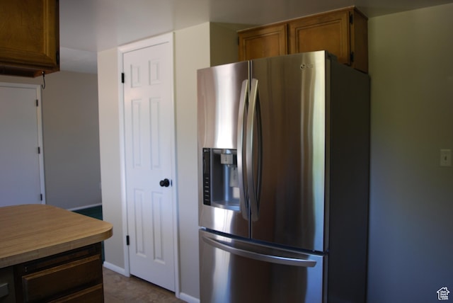 71 Gary Way N, Salt Lake, UT 84054 - kitchen featuring stainless steel fridge with ice dispenser, brown cabinets, and light countertops