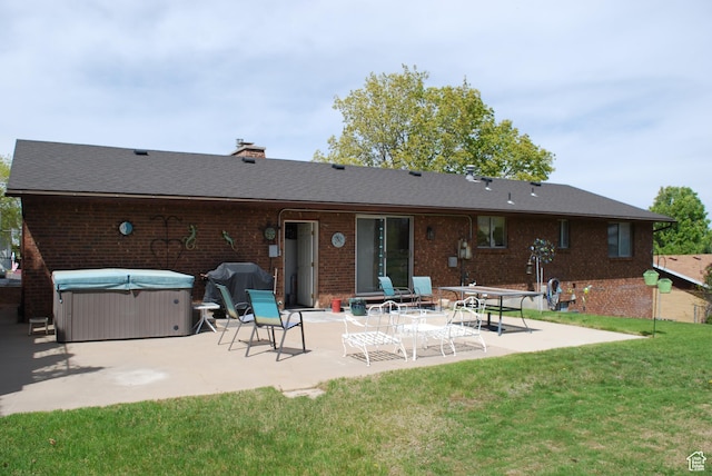 71 Gary Way N, Salt Lake, UT 84054 - back of property featuring a patio area, a yard, a chimney, a hot tub, and brick siding