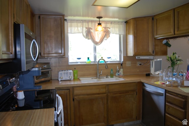 71 Gary Way N, Salt Lake, UT 84054 - kitchen featuring a sink, appliances with stainless steel finishes, light countertops, brown cabinetry, and backsplash