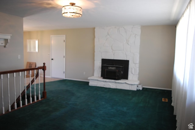 71 Gary Way N, Salt Lake, UT 84054 - unfurnished living room with carpet flooring, a stone fireplace, and healthy amount of natural light