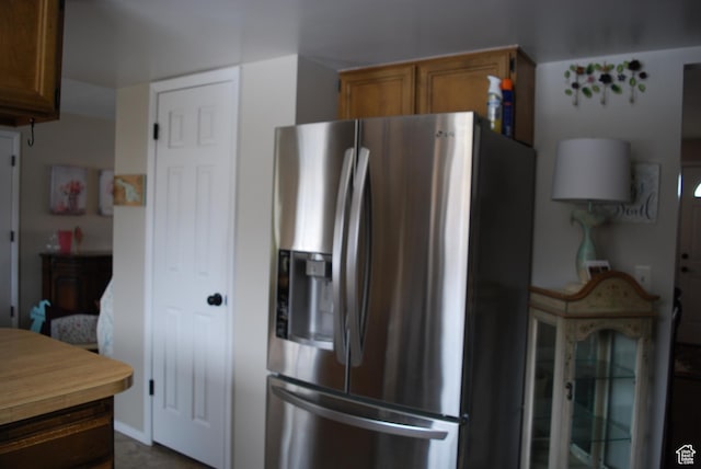 71 Gary Way N, Salt Lake, UT 84054 - kitchen featuring light countertops, brown cabinetry, and stainless steel fridge with ice dispenser