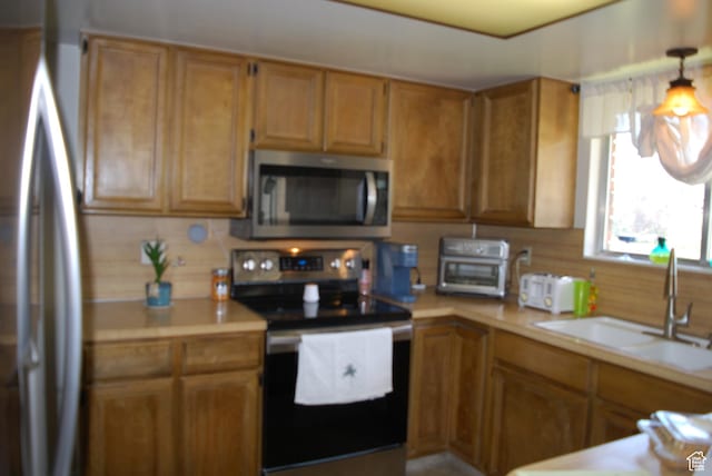 71 Gary Way N, Salt Lake, UT 84054 - kitchen with a sink, brown cabinets, stainless steel appliances, and light countertops