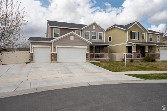 12172 S Window Arch Ln, Herriman, UT 84096 - craftsman-style home with a gate, fence, a front lawn, driveway, and a porch