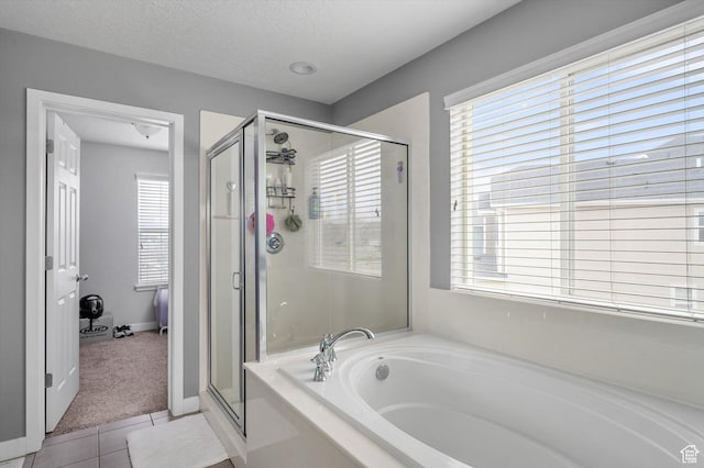 12172 S Window Arch Ln, Herriman, UT 84096 - full bathroom featuring tile patterned floors, a stall shower, a textured ceiling, and a bath