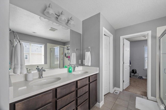 12172 S Window Arch Ln, Herriman, UT 84096 - bathroom featuring double vanity, a sink, a stall shower, and tile patterned floors