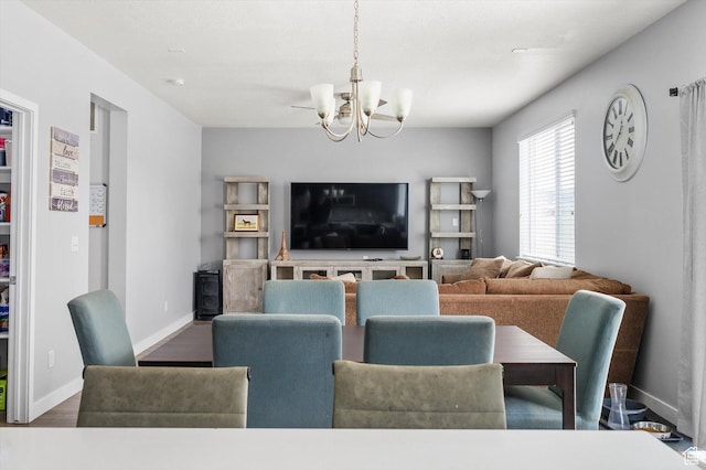 12172 S Window Arch Ln, Herriman, UT 84096 - dining area featuring a notable chandelier, baseboards, and wood finished floors