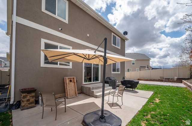12172 S Window Arch Ln, Herriman, UT 84096 - back of property with stucco siding, fence, and a patio area