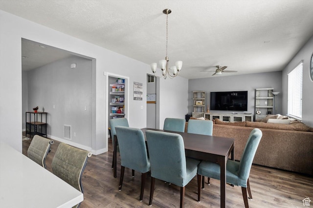 12172 S Window Arch Ln, Herriman, UT 84096 - dining area featuring wood finished floors, a textured ceiling, baseboards, ceiling fan with notable chandelier, and visible vents