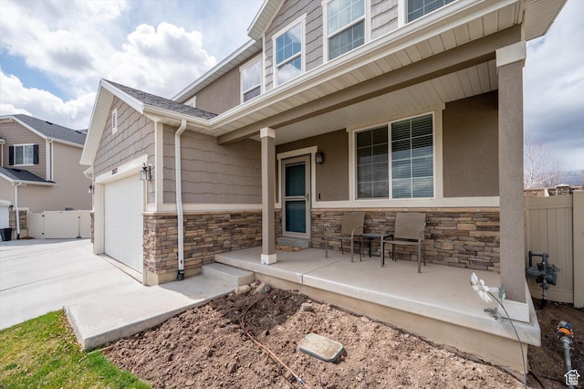 12172 S Window Arch Ln, Herriman, UT 84096 - view of patio featuring fence, covered porch, and a garage