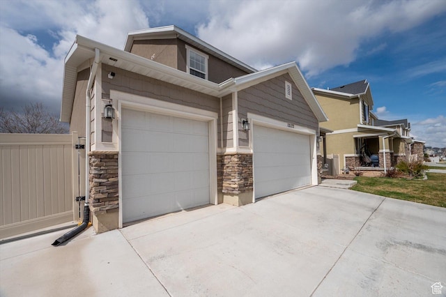 12172 S Window Arch Ln, Herriman, UT 84096 - view of side of property with stone siding, a garage, concrete driveway, and fence