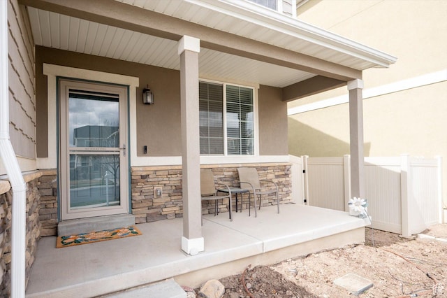 12172 S Window Arch Ln, Herriman, UT 84096 - property entrance featuring stone siding, fence, a porch, and stucco siding