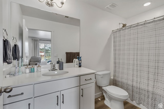 1436 S Divide Dr, Santaquin, UT 84655 - ensuite bathroom featuring visible vents, toilet, wood finished floors, vanity, and ensuite bath
