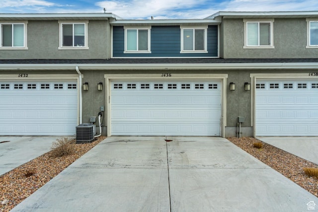 1436 S Divide Dr, Santaquin, UT 84655 - view of front of home with cooling unit, concrete driveway, stucco siding, and an attached garage