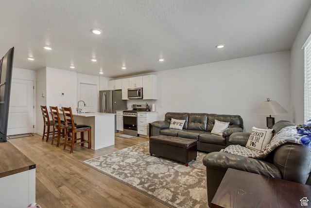 1436 S Divide Dr, Santaquin, UT 84655 - living room featuring light wood finished floors, recessed lighting, and a textured ceiling
