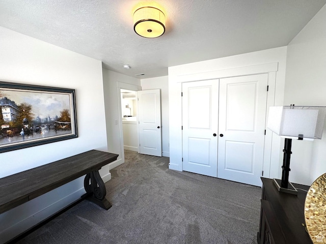 352 W Ropelato Dr, Nibley, UT 84321 - bedroom with dark carpet, a closet, a textured ceiling, and baseboards