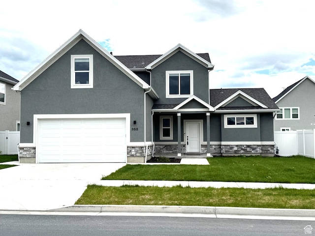 352 W Ropelato Dr, Nibley, UT 84321 - view of front of property with stone siding, stucco siding, concrete driveway, and a garage