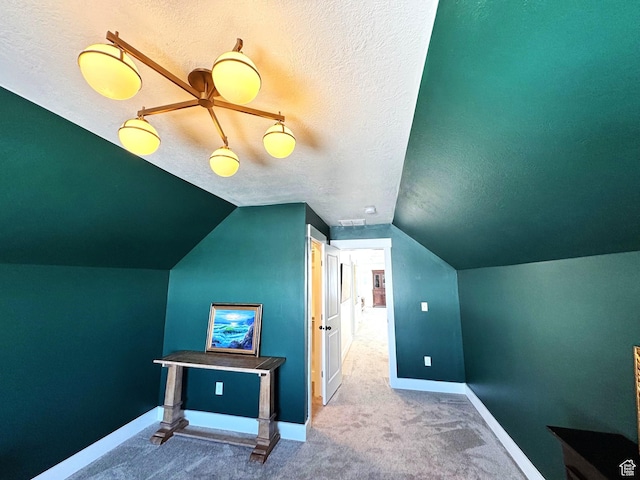 352 W Ropelato Dr, Nibley, UT 84321 - additional living space featuring a textured ceiling, carpet flooring, baseboards, and vaulted ceiling