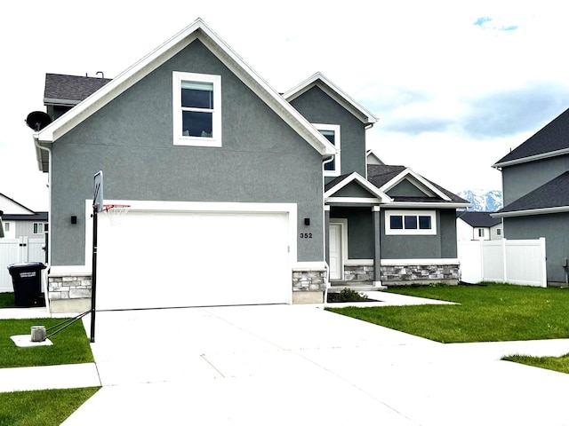 352 W Ropelato Dr, Nibley, UT 84321 - view of front of property with stone siding, stucco siding, concrete driveway, and an attached garage