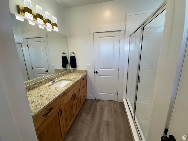 352 W Ropelato Dr, Nibley, UT 84321 - bathroom featuring wood finished floors, a shower stall, and vanity