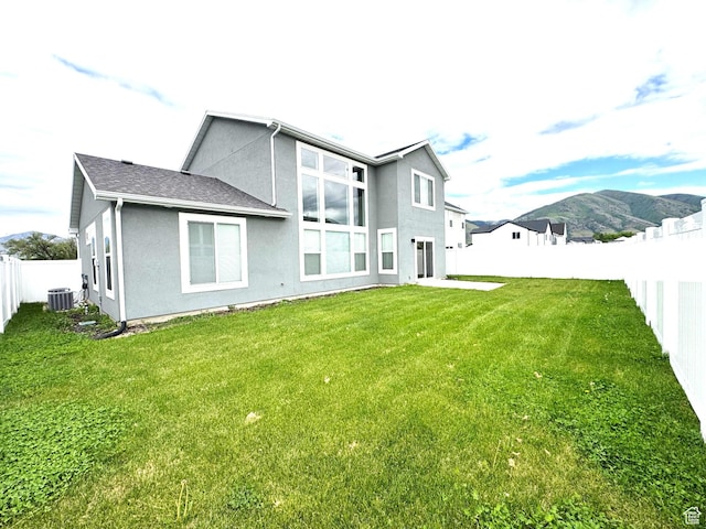 352 W Ropelato Dr, Nibley, UT 84321 - rear view of property with central AC, stucco siding, and a mountain view