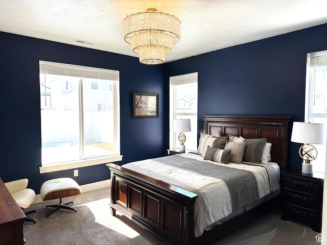 352 W Ropelato Dr, Nibley, UT 84321 - carpeted bedroom with multiple windows, a chandelier, and baseboards