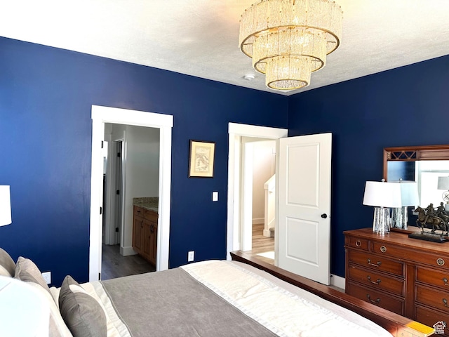 352 W Ropelato Dr, Nibley, UT 84321 - bedroom featuring a chandelier, wood finished floors, and baseboards