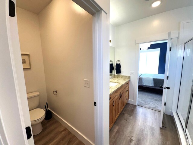 352 W Ropelato Dr, Nibley, UT 84321 - bathroom with wood finished floors, toilet, vanity, and baseboards