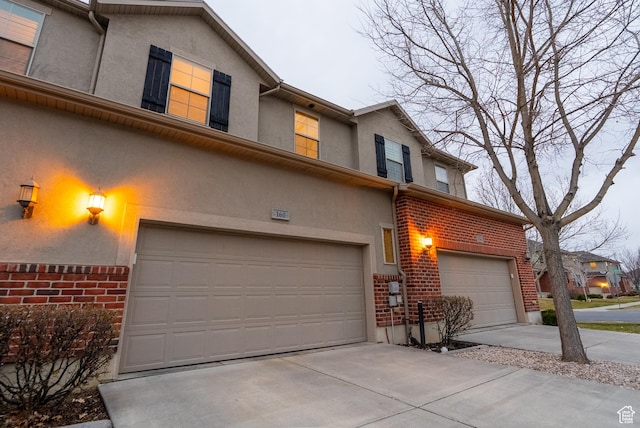 160 S 2775 W, West Point, UT 84015 - townhome / multi-family property featuring brick siding, stucco siding, driveway, and a garage
