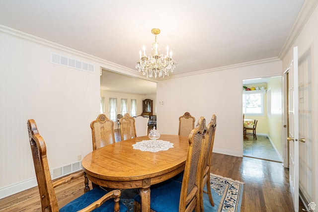 2536 N 575 E, North Ogden, UT 84414 - dining space featuring ornamental molding, plenty of natural light, wood finished floors, a chandelier, and baseboards