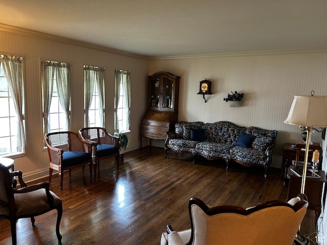 living room with wood finished floors, baseboards, and ornamental molding
